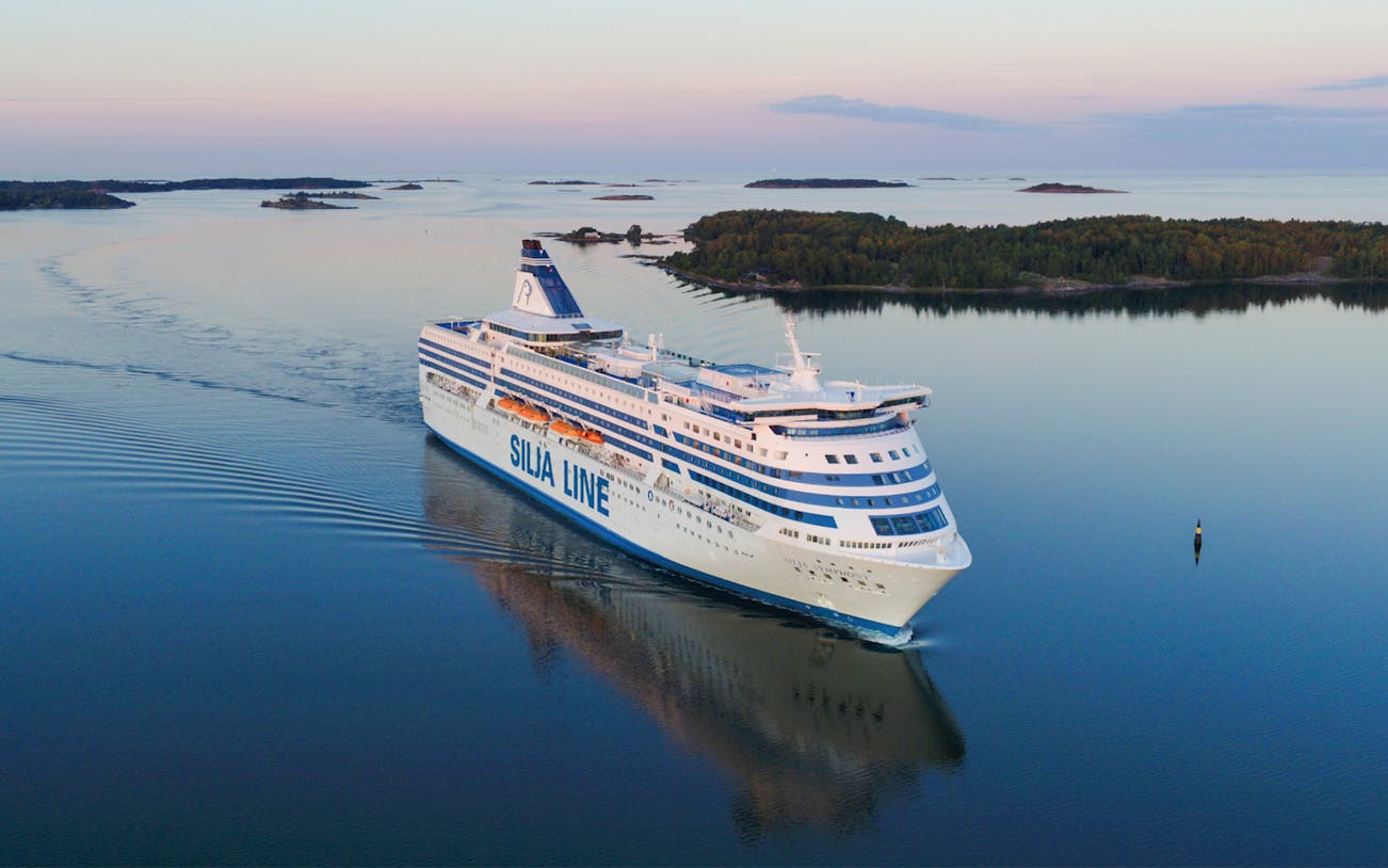 Overnight ferry to Helsinki sailing through calm waters, aerial view.