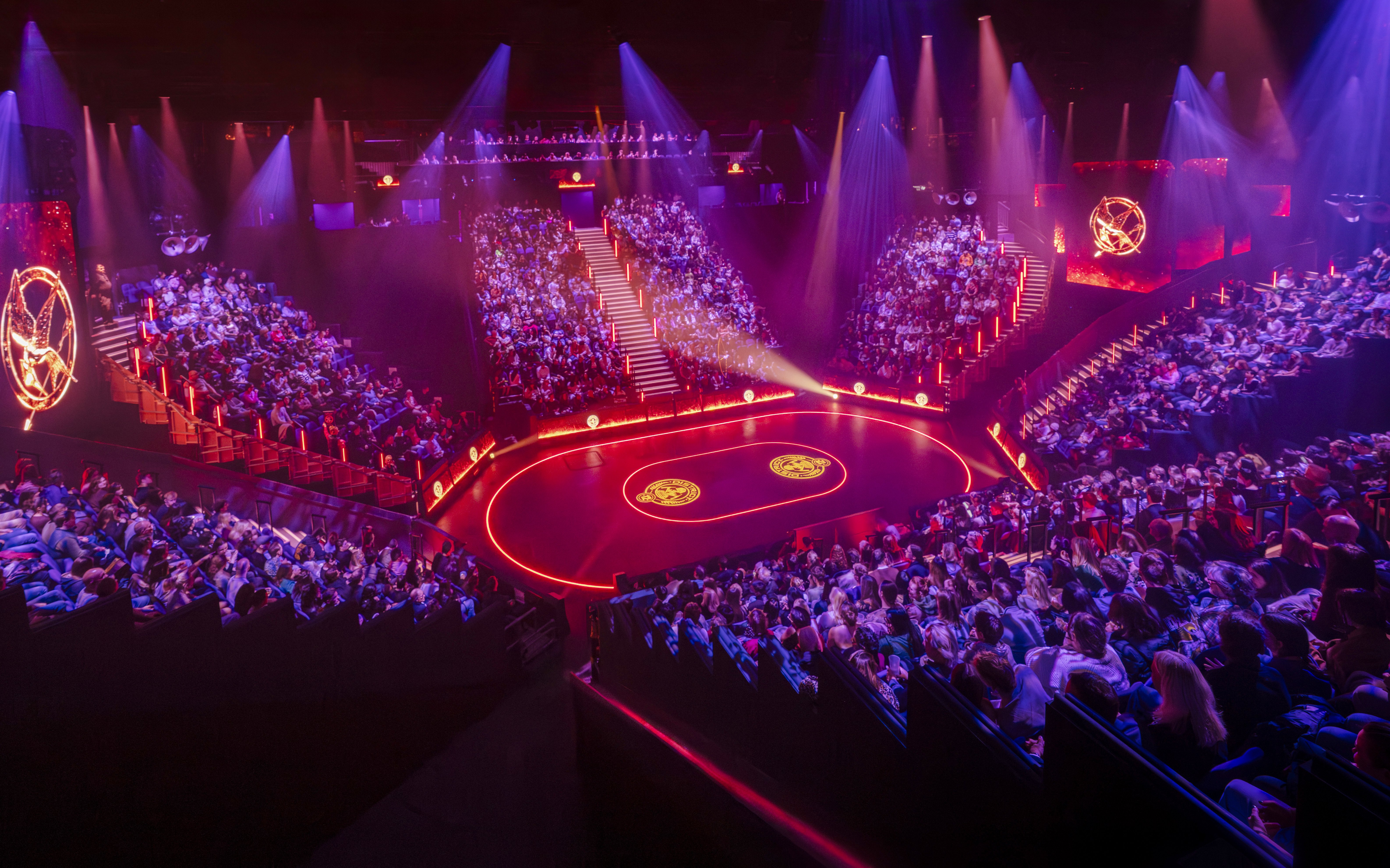 Hunger Games West End show stage with audience in a circular theater setting.