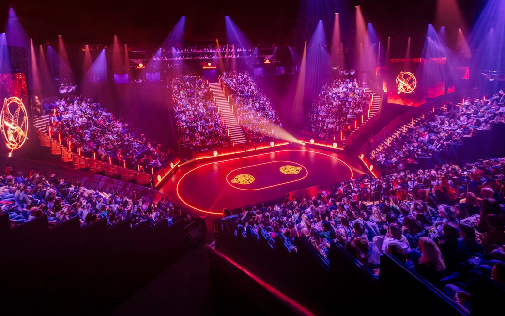 Hunger Games West End show stage with audience in a circular theater setting.