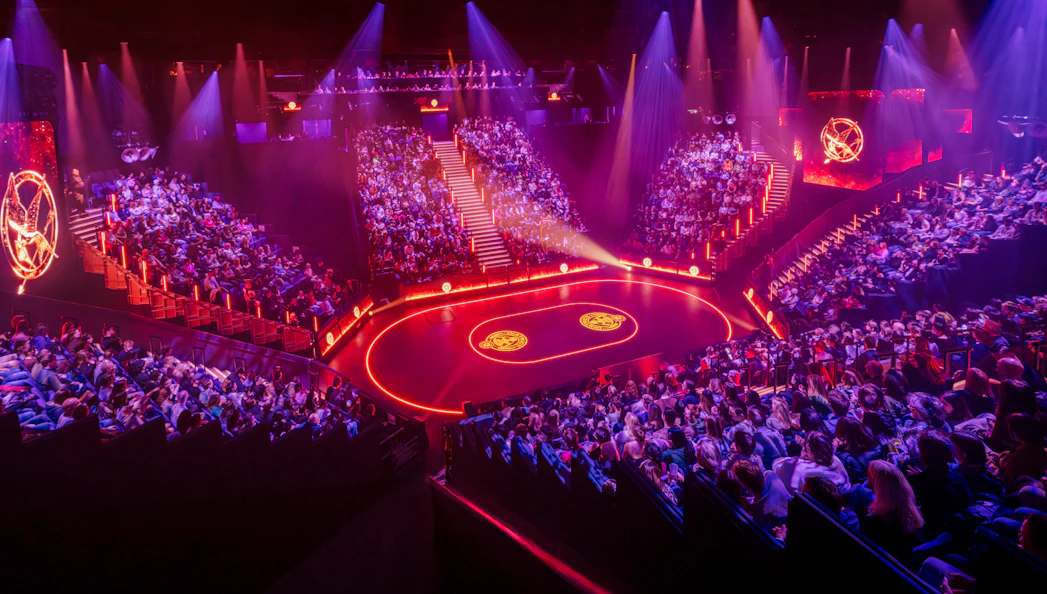 Hunger Games West End show stage with audience in a circular theater setting.