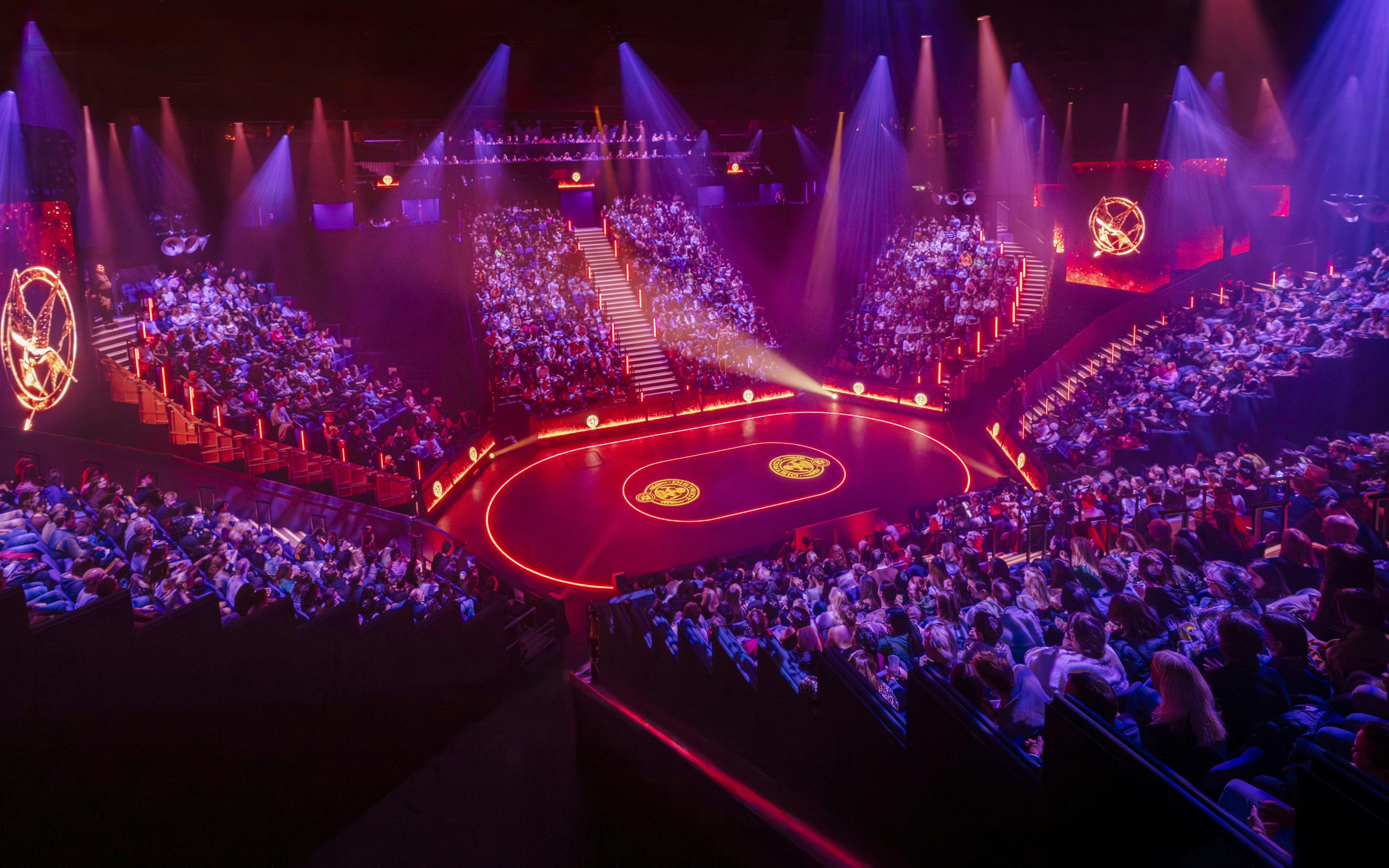 Hunger Games West End show stage with audience in a circular theater setting.