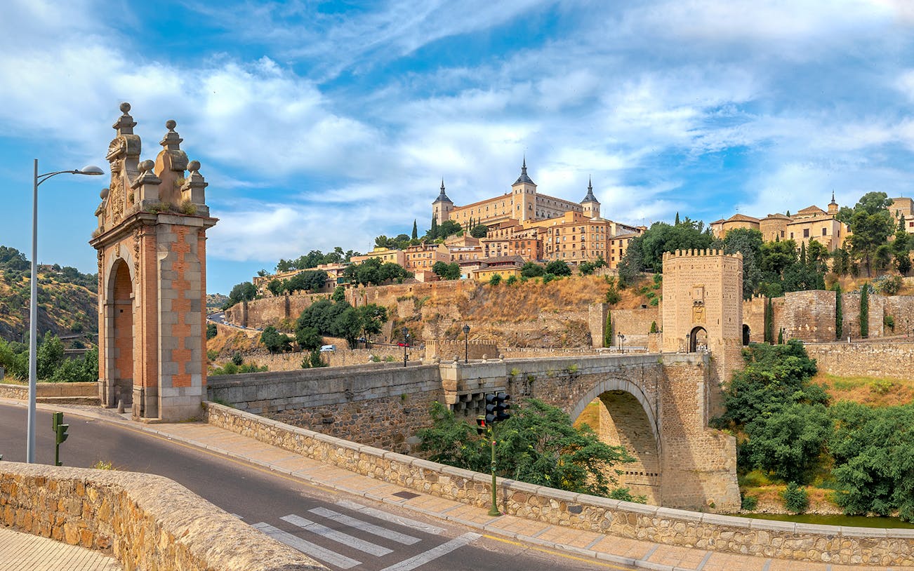 Alcazar and San Martin Bridge in Toledo with historic architecture and scenic landscape.