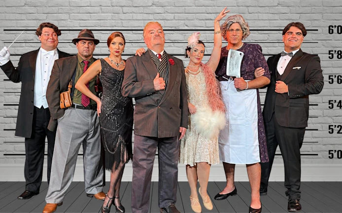 Guests in 1920s attire at Buena Park speakeasy murder mystery dinner show.