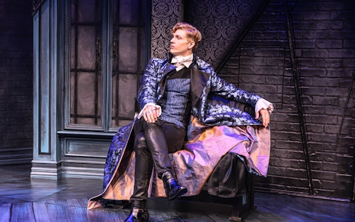 Actor in Victorian attire on stage for "Dracula, A Comedy of Terrors" performance.