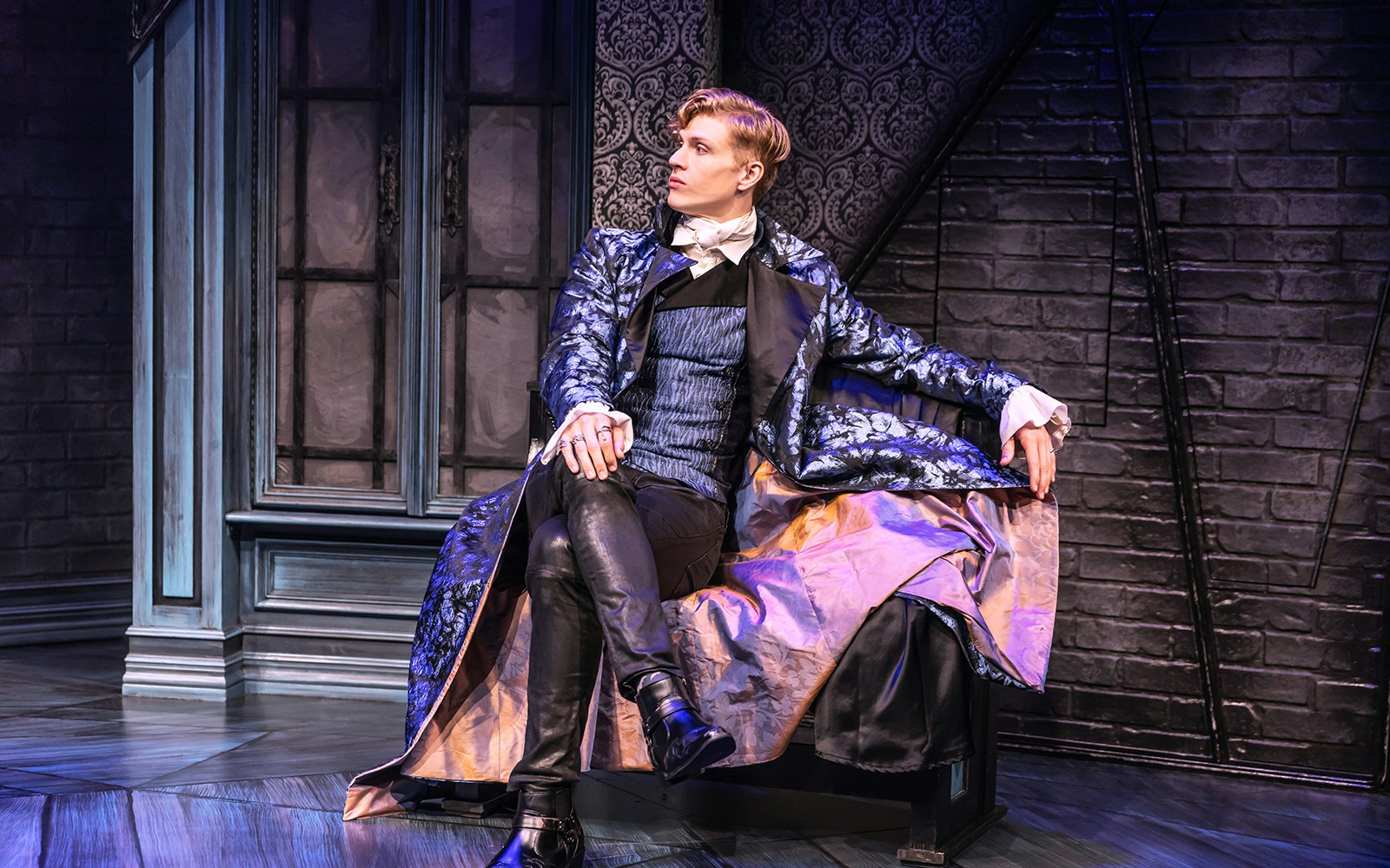 Actor in Victorian attire on stage for "Dracula, A Comedy of Terrors" performance.