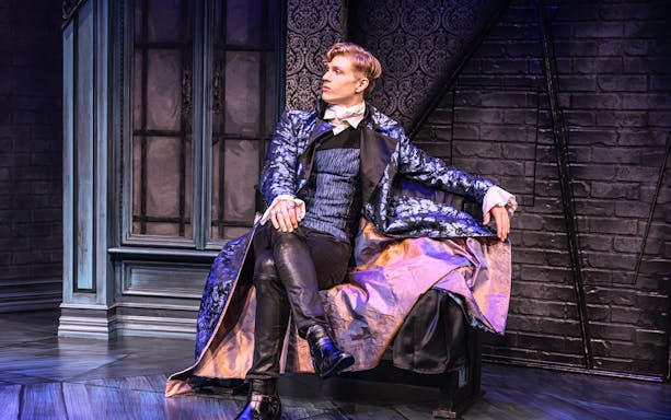 Actor in Victorian attire on stage for "Dracula, A Comedy of Terrors" performance.