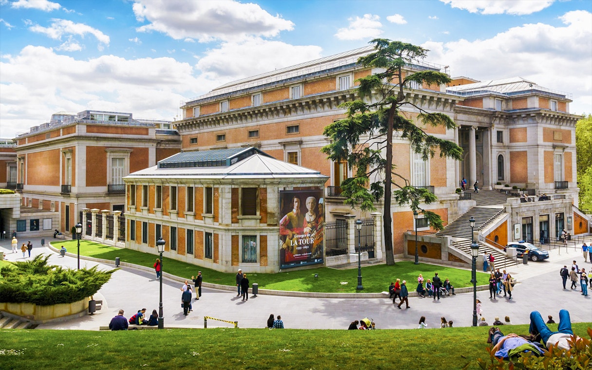 Tourists outside Prado Museum in Madrid during a guided tour.