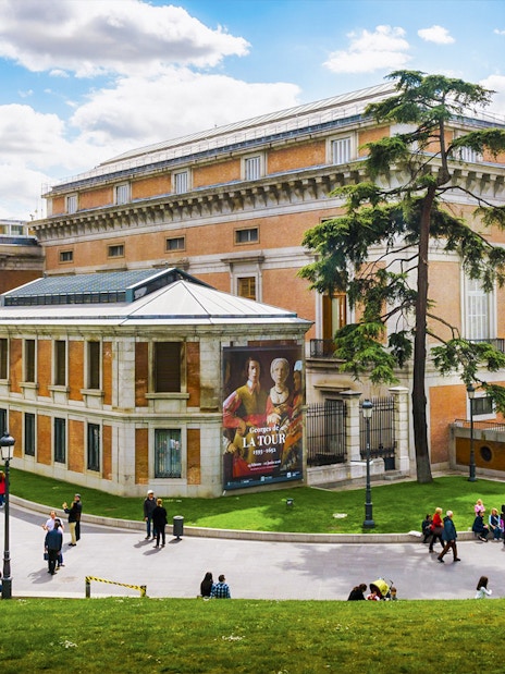 Tourists outside Prado Museum in Madrid during a guided tour.