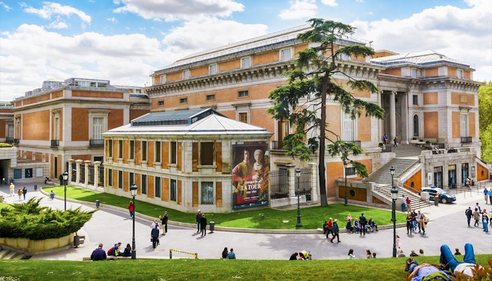 Tour guide explaining famous artworks to tourists at Prado Museum, Madrid during skip-the-line tour.