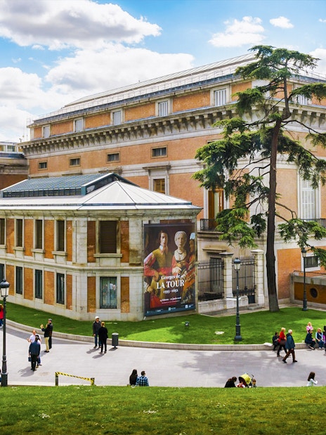 Tourists outside Prado Museum in Madrid during a guided tour.