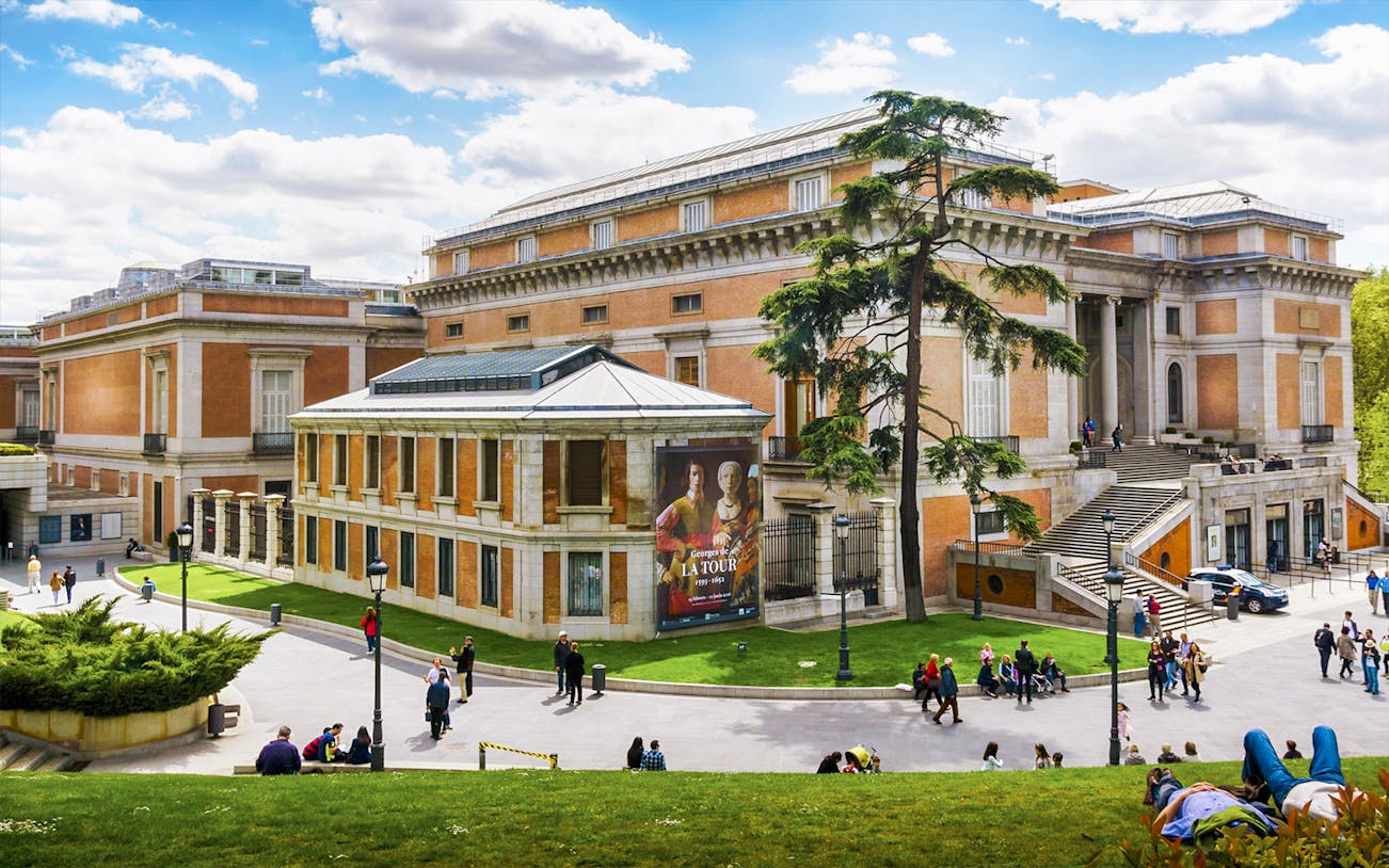 Tourists outside Prado Museum in Madrid during a guided tour.