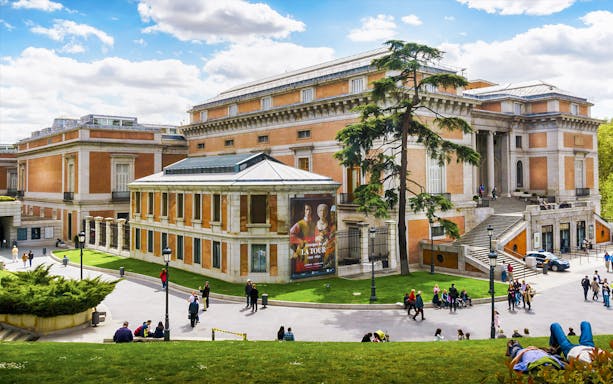 Tourists outside Prado Museum in Madrid during a guided tour.