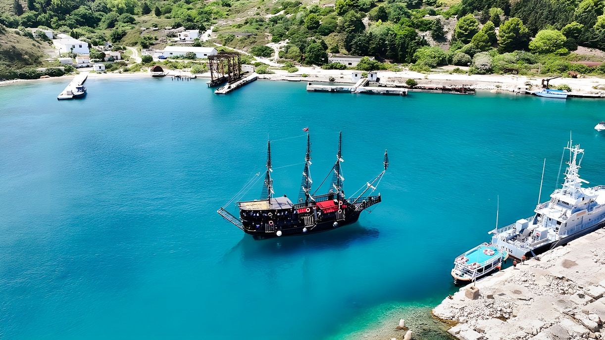 Pirate ship in Vlora's turquoise waters, part of the Ionian Odyssey tour, Albania.