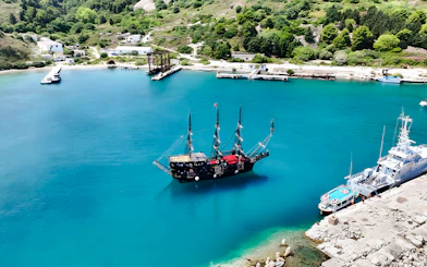 Pirate ship in Vlora's turquoise waters, part of the Ionian Odyssey tour, Albania.