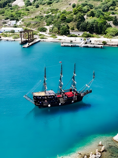 Pirate ship in Vlora's turquoise waters, part of the Ionian Odyssey tour, Albania.