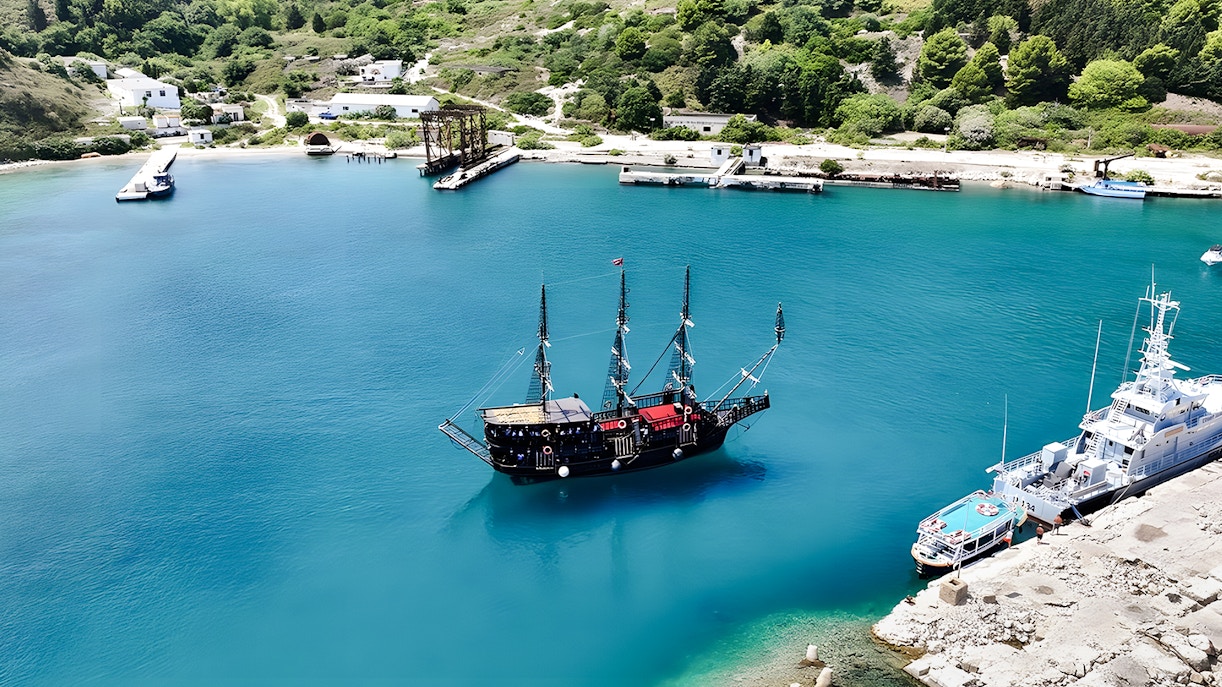 Pirate ship in Vlora's turquoise waters, part of the Ionian Odyssey tour, Albania.