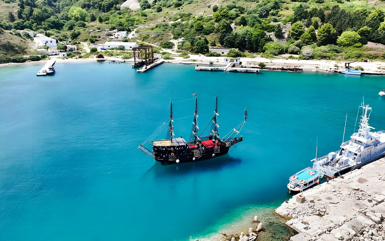 Pirate ship in Vlora's turquoise waters, part of the Ionian Odyssey tour, Albania.