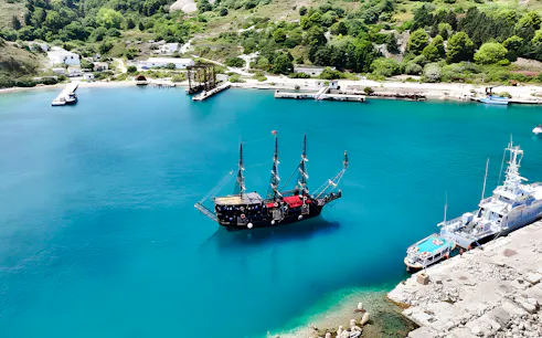 Pirate ship in Vlora's turquoise waters, part of the Ionian Odyssey tour, Albania.