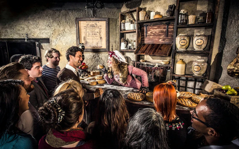 Guests interacting with a performer at the London Dungeon VIP Package experience.