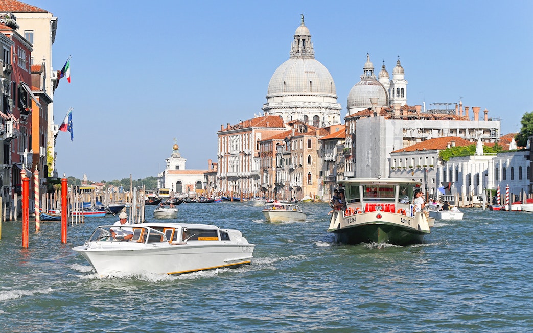 ACTV water bus navigating Grand Canal with Santa Maria della Salute in Venice.