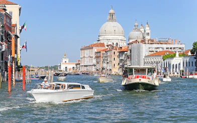 ACTV water bus navigating Grand Canal with Santa Maria della Salute in Venice.