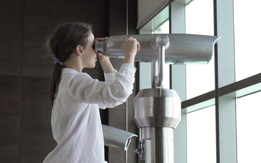 Person using a telescope at The View At The Palm, Dubai.