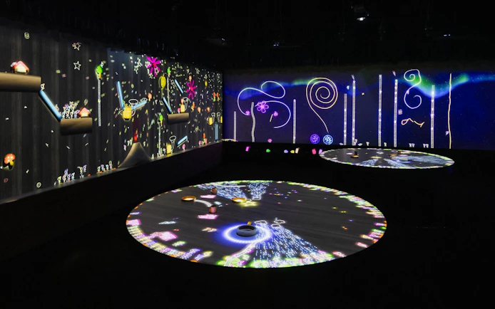 Interactive digital musical wall with colorful projections and patterns.