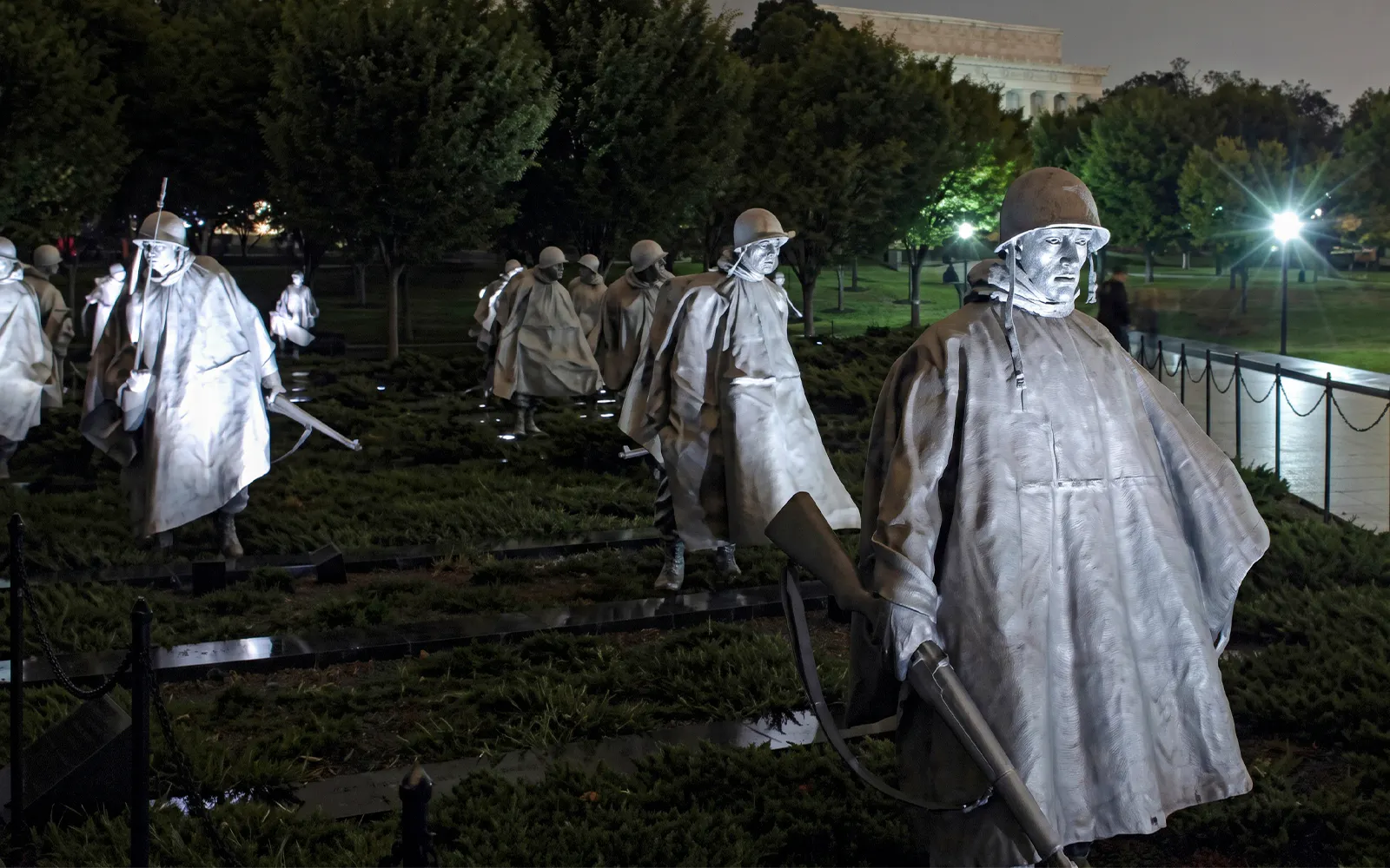 Korean War Veterans Memorial statues illuminated at night, Washington DC.