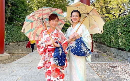Women in kimonos holding umbrellas during an authentic cultural experience in Japan.