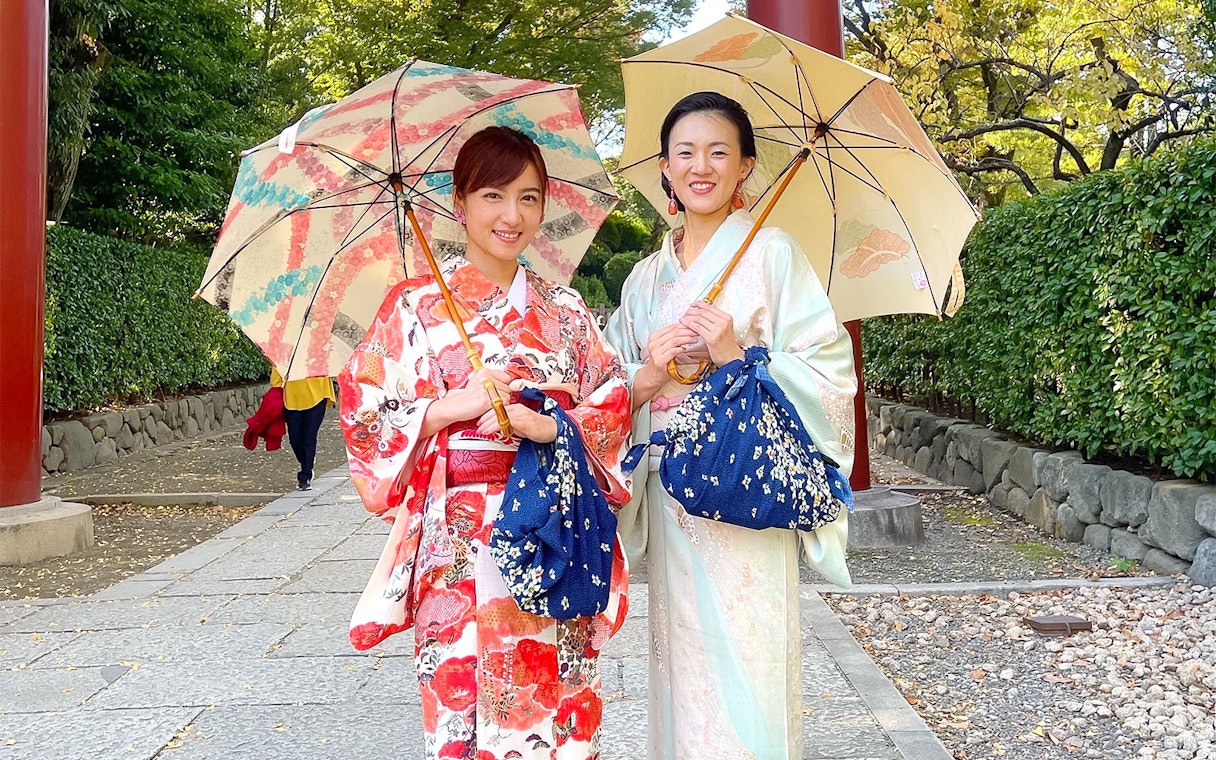 Women in kimonos holding umbrellas during an authentic cultural experience in Japan.