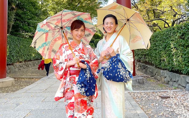 Women in kimonos holding umbrellas during an authentic cultural experience in Japan.