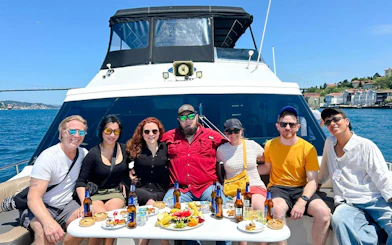 Group enjoying Bosphorus Yacht Sightseeing Cruise with snacks and drinks, Istanbul.