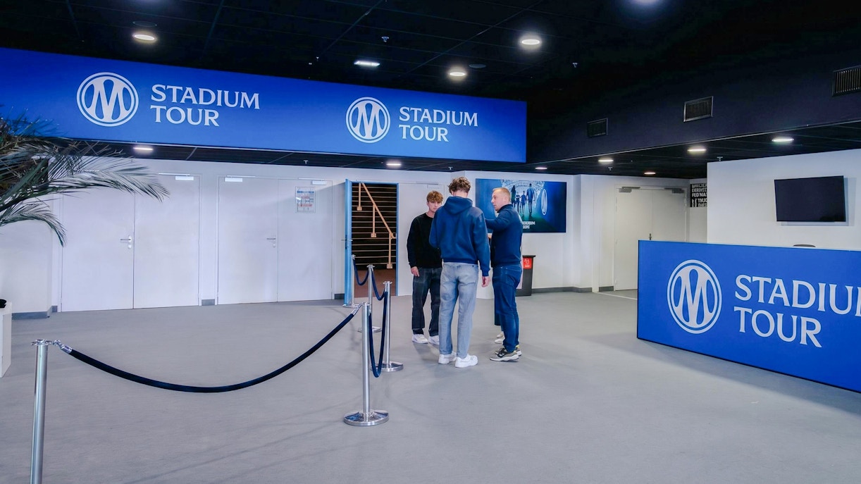 OM Stadium Tour entrance with visitors and signage.