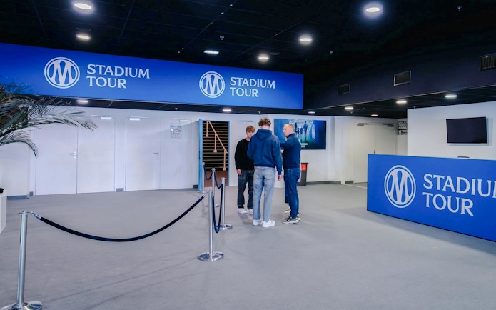 OM Stadium Tour entrance with visitors and signage.