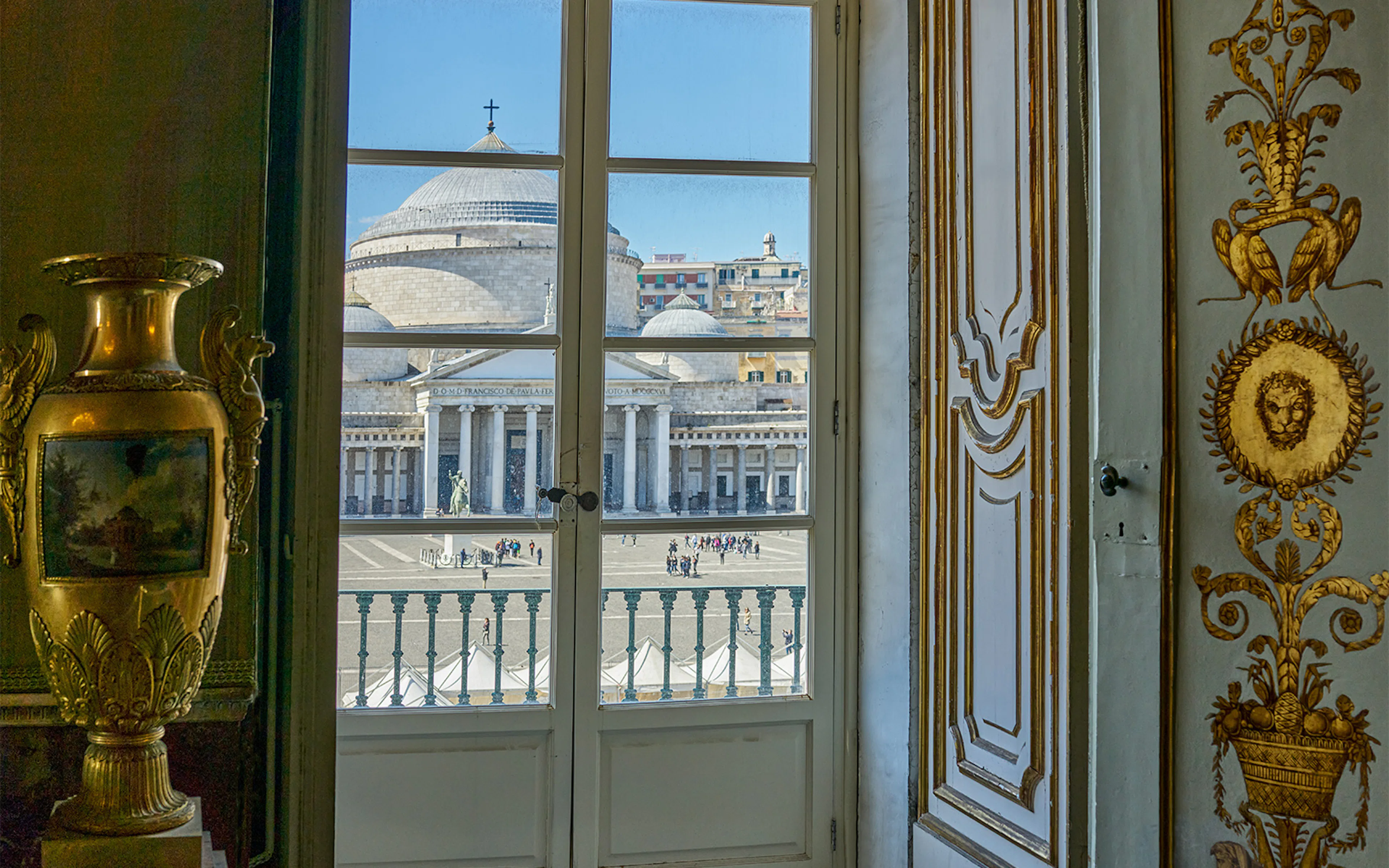 Royal Palace of Naples interior with ornate vase and view of Piazza del Plebiscito.