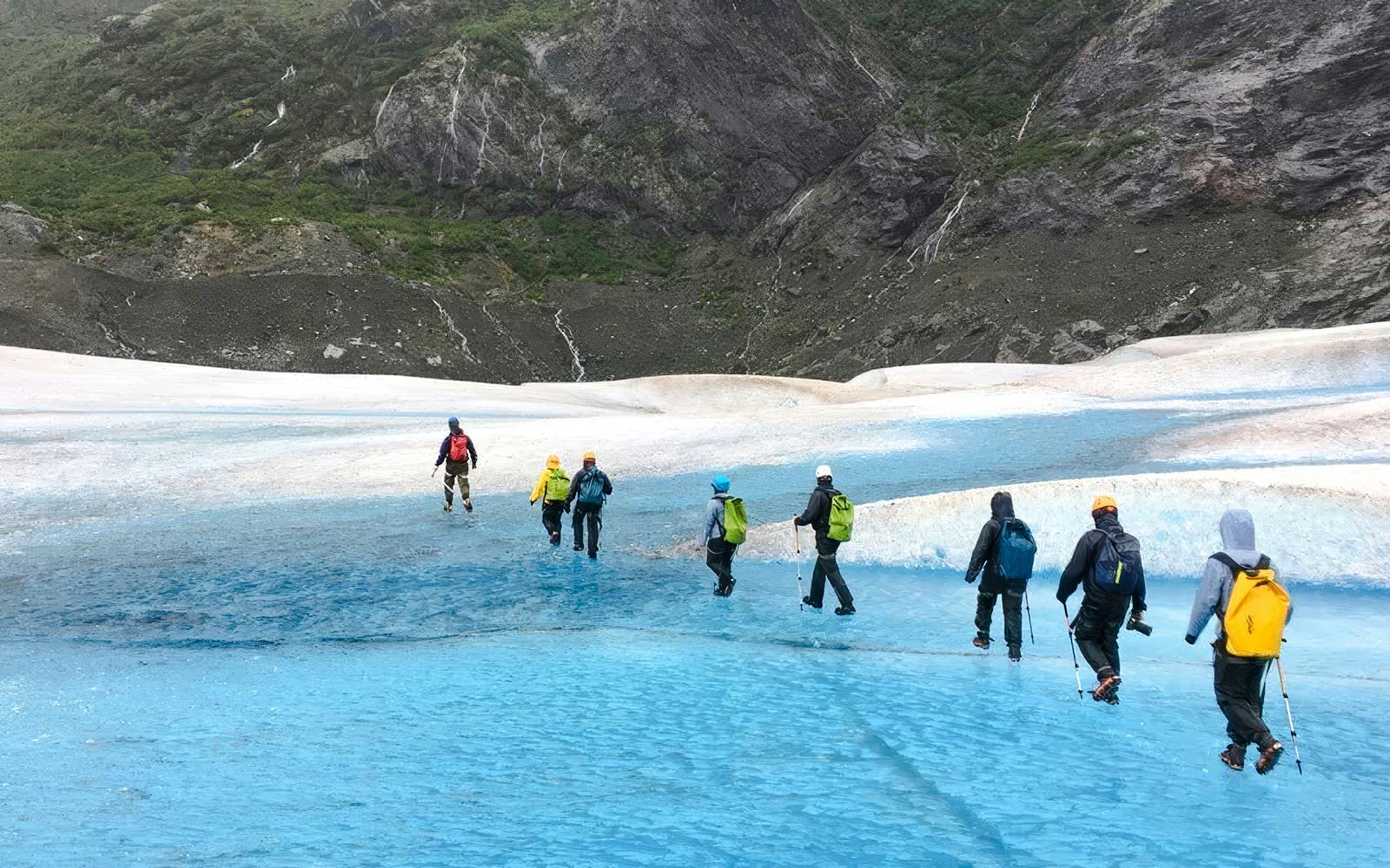 Hikers trekking across Mendenhall Glacier in Alaska.