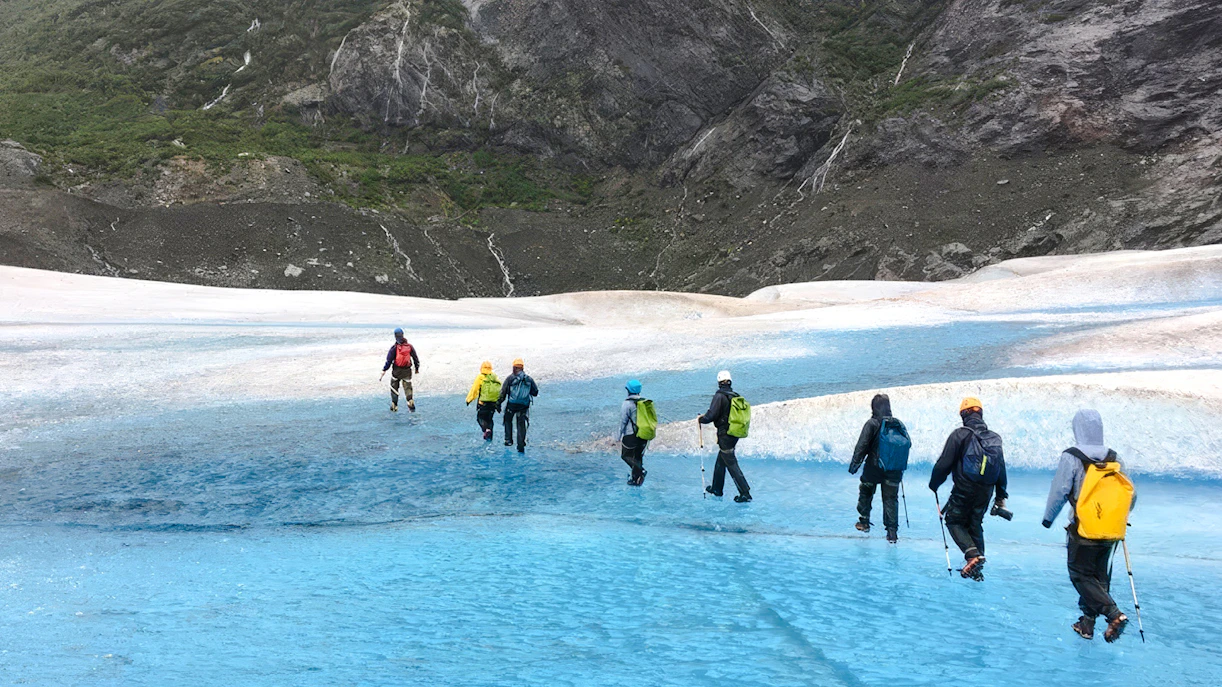Hikers trekking across Mendenhall Glacier in Alaska.