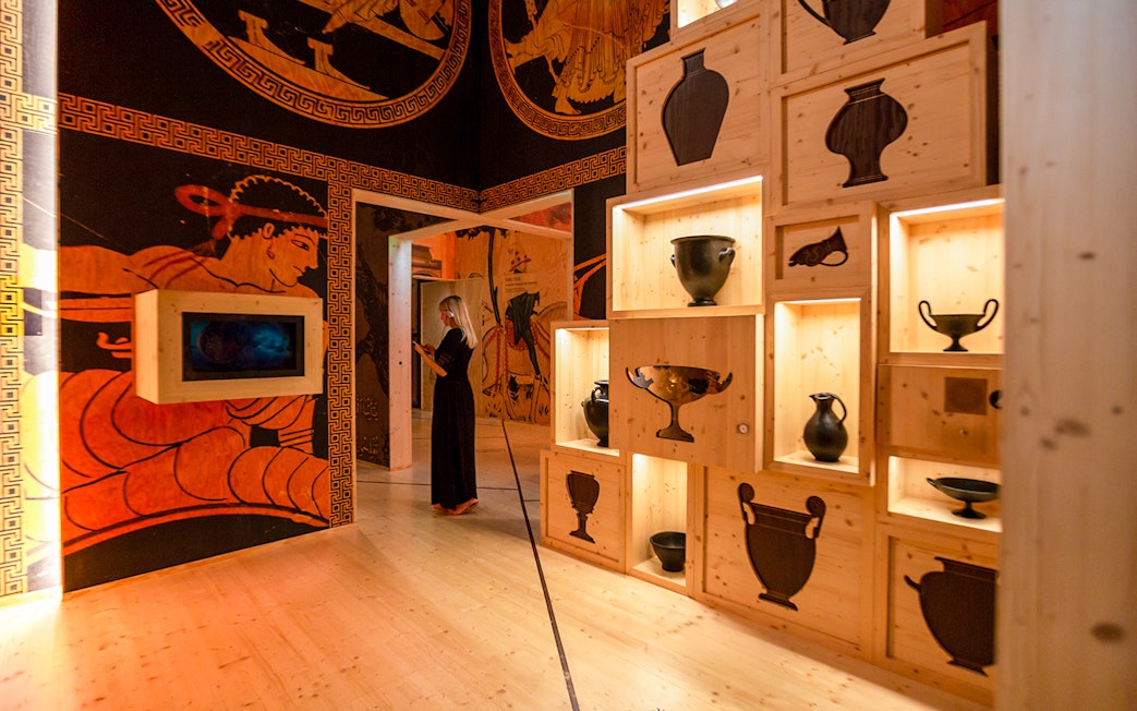 Visitors exploring wine exhibits at Cité du Vin museum in Bordeaux, France.