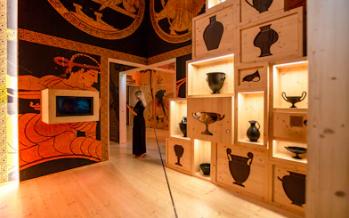 Visitors exploring wine exhibits at Cité du Vin museum in Bordeaux, France.