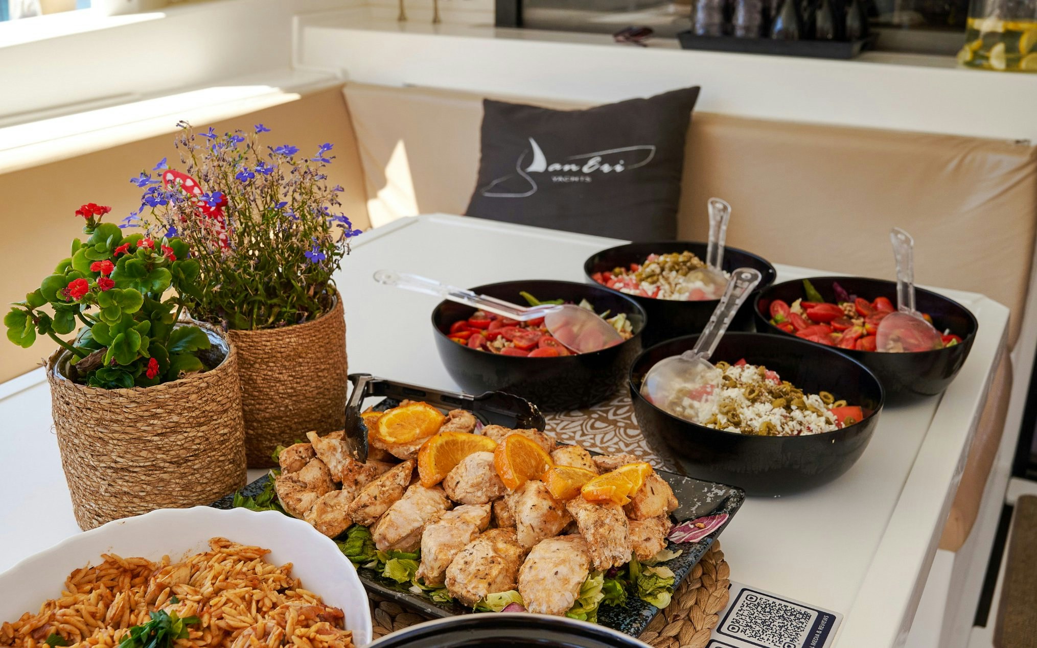 Grilled chicken and salads on a luxury catamaran cruise near Dia Island, Crete.