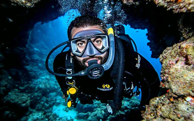 Diver exploring coral reef in Hurghada during sunset intro dive.