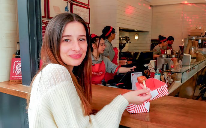 Customer enjoying street food at a local eatery in Athens Old Town.