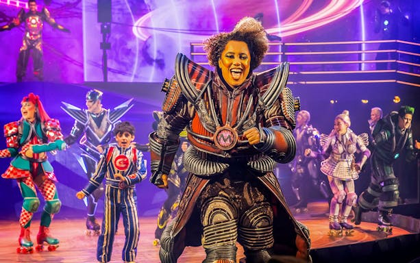 Performers in futuristic costumes on stage during Starlight Express show.