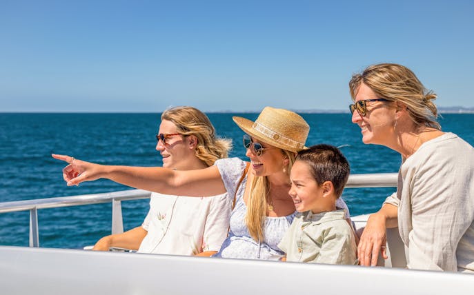Family enjoying a cruise on the Guadalquivir River in Seville.