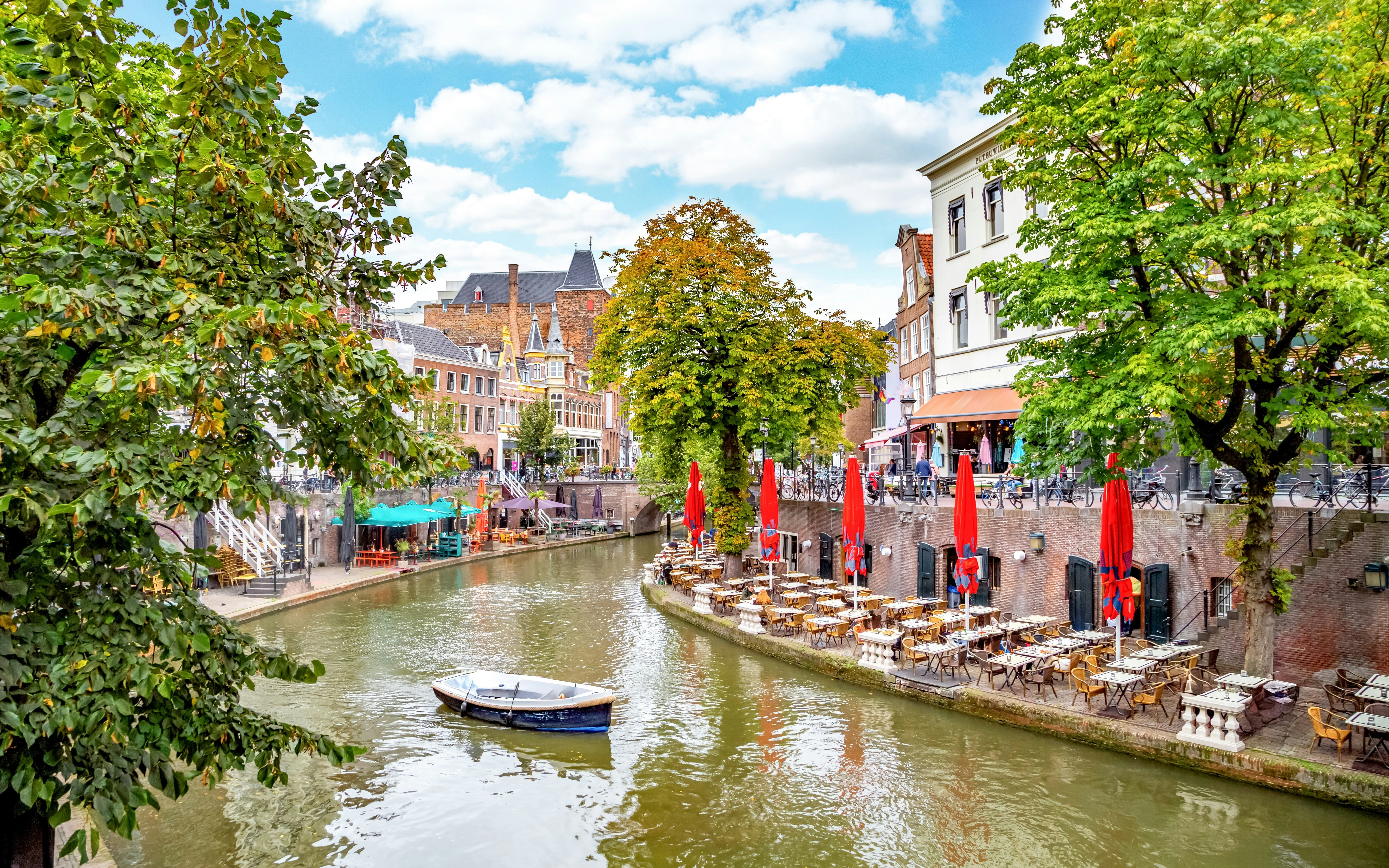 Canal-side cafes and boat on Oudegracht in Utrecht.