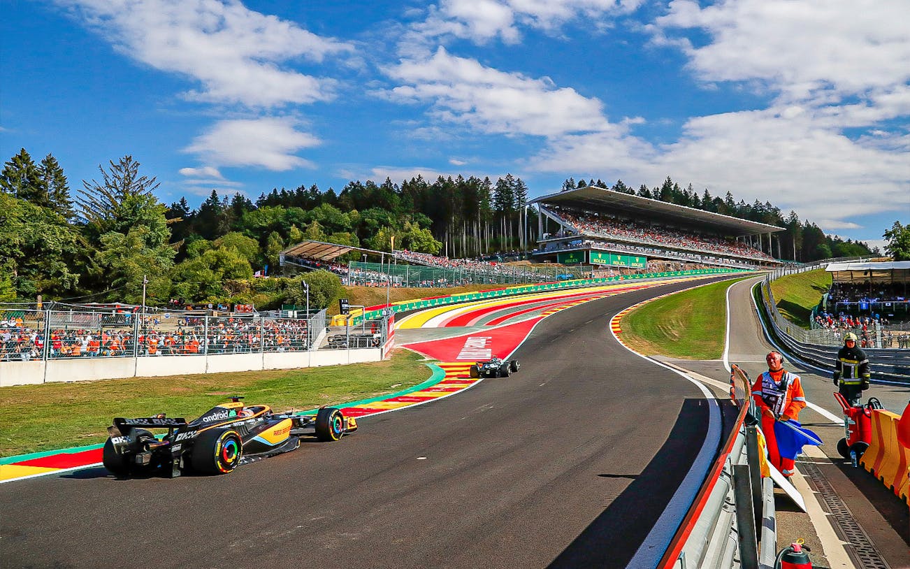 Race cars on track at Formula 1 Belgian Grand Prix, Spa-Francorchamps circuit.