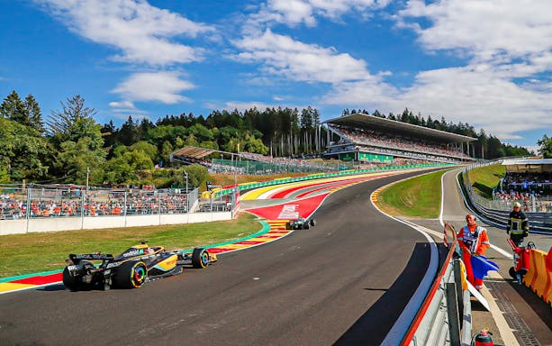 Race cars on track at Formula 1 Belgian Grand Prix, Spa-Francorchamps circuit.