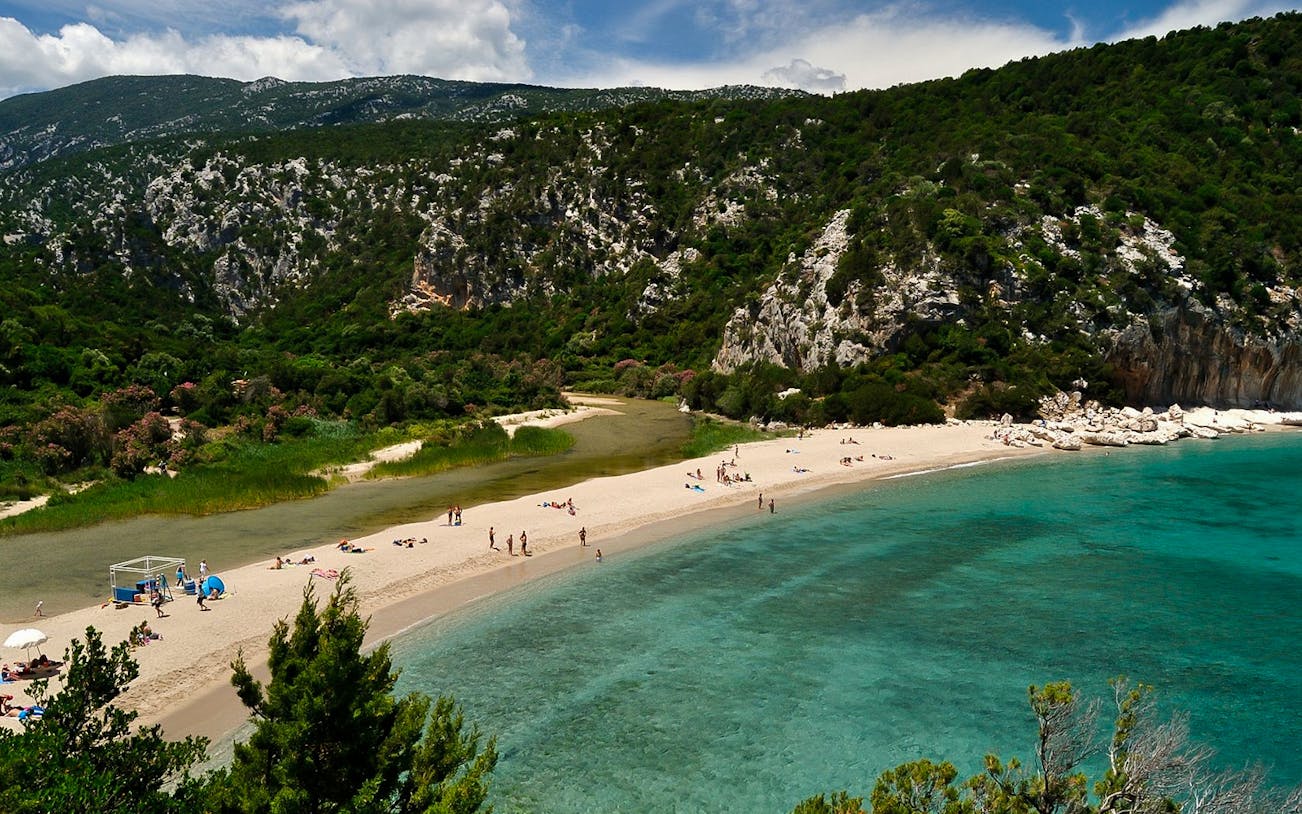 Trekking path leading to Cala Luna beach with turquoise waters in Baunei, Dorgali.