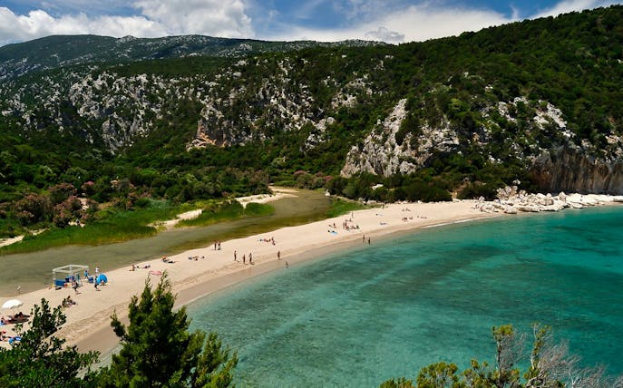 Trekking path leading to Cala Luna beach with turquoise waters in Baunei, Dorgali.
