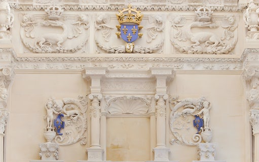 Ornate stone carvings with fleur-de-lis emblem at Cité internationale de la langue française.
